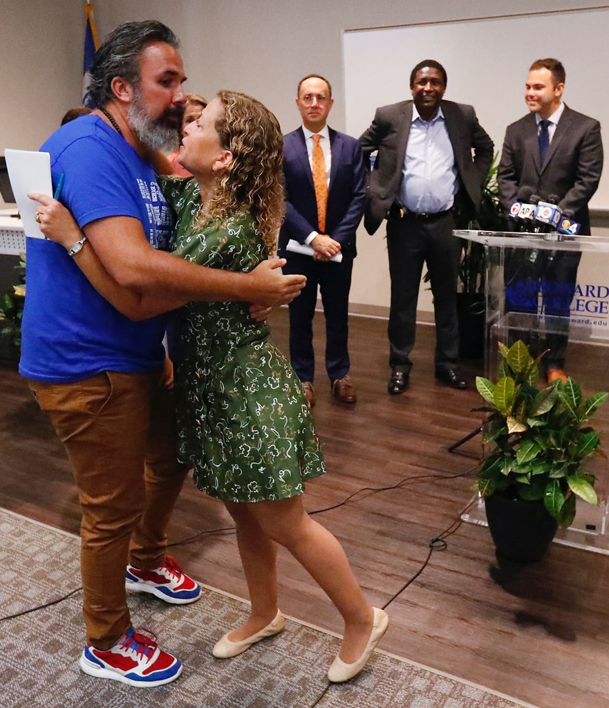 Manuel Oliver, left, father of slain Marjory Stoneman Douglas student Joaquin Oliver, hugs Rep. Debbie Wasserman Schultz, D-Fla., before a news conference